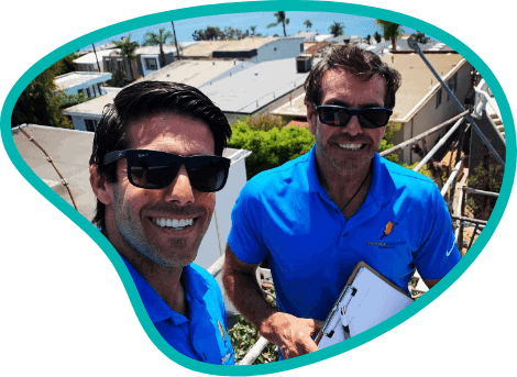 Owners taking selfie from rooftop with the ocean behind them